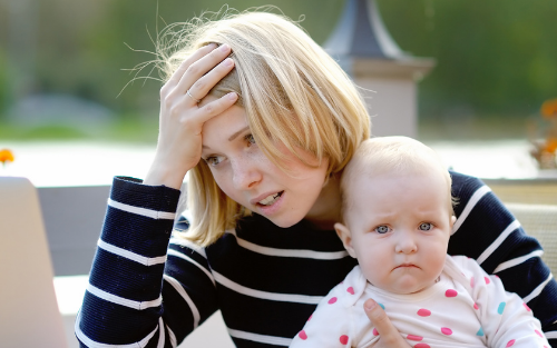 young mum looking stressed | what is postnatal depletion? | Perpetual Wellbeing