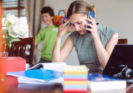 woman frowning on phone | overworked stress response | Perpetual Wellbeing