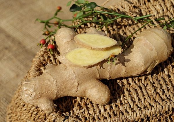 root ginger on a woven table | ginger for period pain